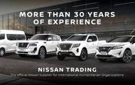 Various White Nissan Vehicles in front of building