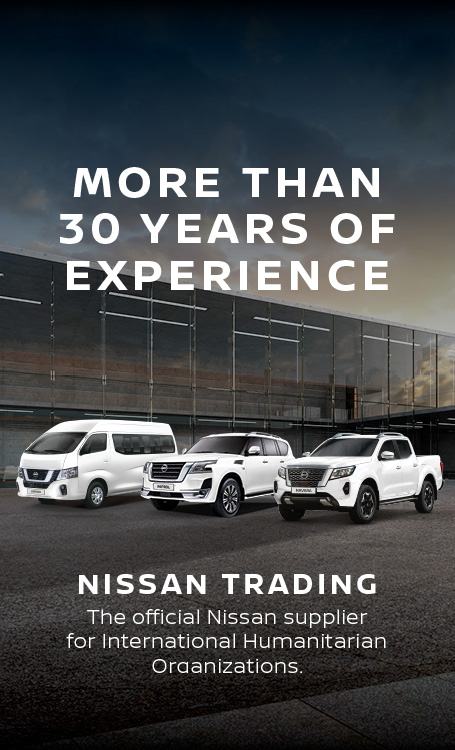 Various White Nissan Vehicles in front of building